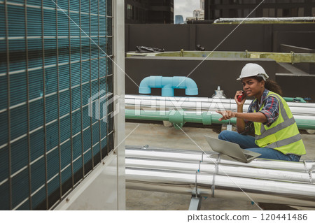 Engineers use laptop for check and look at draft plan of building on constructing site. Engineer working on building site. Engineer working with drawing System plan document Engineers use laptop for check and look at draft plan of building on constructing site. Engineer working on building site. Engineer working with drawing System plan document 120441486