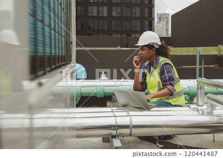 Engineers use laptop for check and look at draft plan of building on constructing site. Engineer working on building site. Engineer working with drawing System plan document 120441487