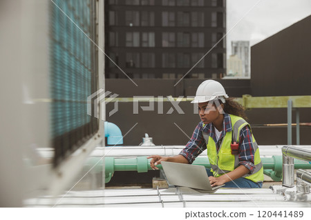 Engineers use laptop for check and look at draft plan of building on constructing site. Engineer working on building site. Engineer working with drawing System plan document 120441489