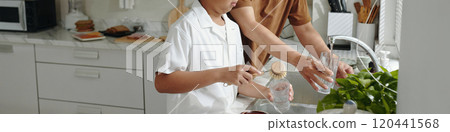 Washing Dishes Together in Bright Kitchen Setting 120441568