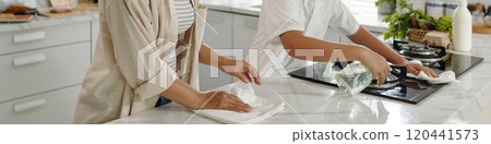 Cleaning Modern White Kitchen Together with Cloth Wipes Cleaning Modern White Kitchen Together with Cloth Wipes 120441573