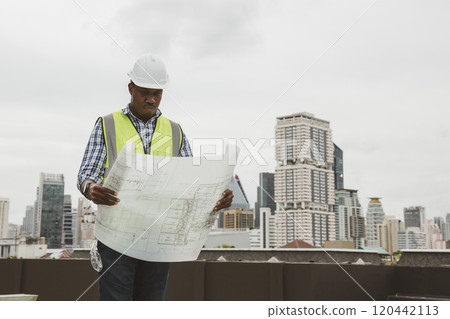 Engineers with draft plan of building on constructing site. Engineer working on building site. Engineer working with drawing System plan document Engineers with draft plan of building on constructing site. Engineer working on building site. Engineer working with drawing System plan document 120442113