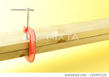 Clamp the lumber to hold it in place 120443126