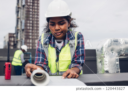 Engineers with draft plan of building on constructing site. Engineer working on building site. Engineer working with drawing System plan document 120443827
