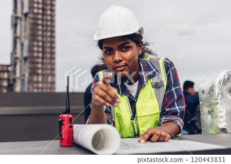 Engineers with draft plan of building on constructing site. Engineer working on building site. Engineer working with drawing System plan document Engineers with draft plan of building on constructing site. Engineer working on building site. Engineer working with drawing System plan document 120443831