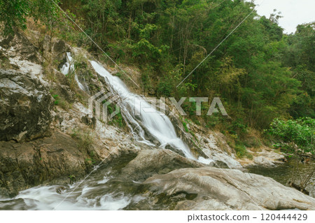 waterfall in summer scene, bright sunrise shining on the waterfall 120444429