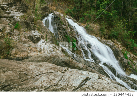 waterfall in summer scene, bright sunrise shining on the waterfall 120444432