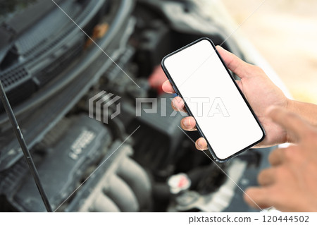 Man using mobile apps or online assistance for automotive diagnostics or emergency services Man using mobile apps or online assistance for automotive diagnostics or emergency services 120444502