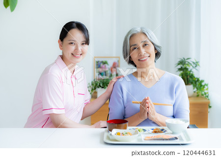Caregiver preparing meals 120444631