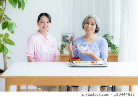 Caregiver preparing meals 120444632