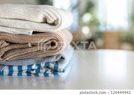 Neatly folded warm knitted sweater stack clothes storage top view isolated on white Neatly folded warm knitted sweater stack clothes storage top view isolated on white 120444942
