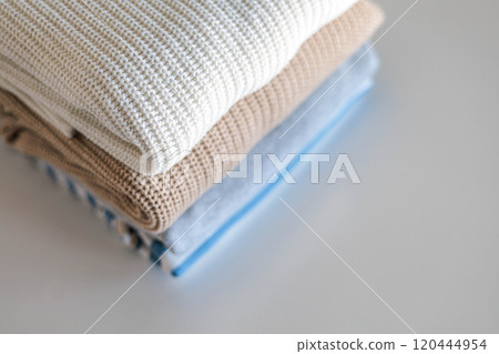 Neatly folded warm knitted sweater stack clothes storage top view isolated on white Neatly folded warm knitted sweater stack clothes storage top view isolated on white 120444954