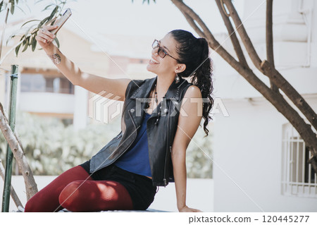 Close-up of a girl taking a selfie, urban girl taking a selfie outdoors, lifestyle woman smiling and taking a selfie Close-up of a girl taking a selfie, urban girl taking a selfie outdoors, lifestyle woman smiling and taking a selfie 120445277