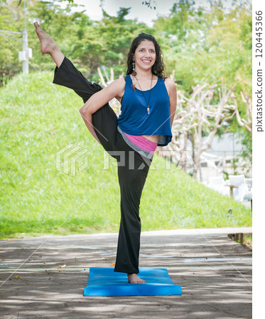 Girl doing yoga bird of paradise, a girl doing yoga outdoors, A woman doing balance yoga, person doing yoga Svarga Dvijasana 120445366
