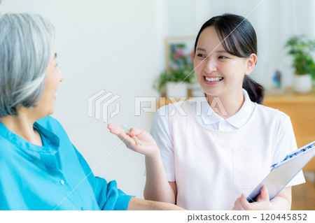 Caregiver supporting a woman in a wheelchair Caregiver supporting a woman in a wheelchair 120445852
