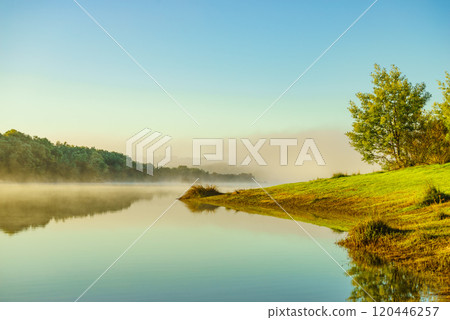 Morning fog over autumn lake water Morning fog over autumn lake water 120446257