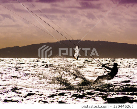 Kite surfer riding waves. Kiteboarding sport. 120446265