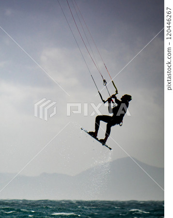 Kite surfer riding waves. Kiteboarding sport. 120446267