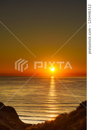 Sunrise over sea water 120446312