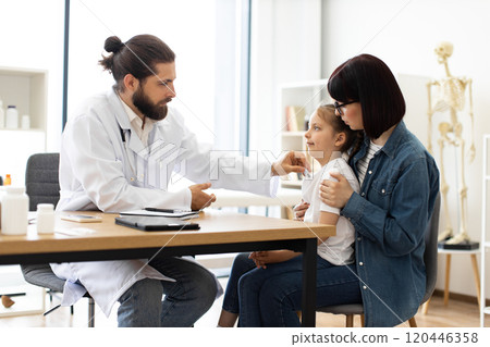Caucasian doctor measuring temperature of sick girl in clinic Caucasian doctor measuring temperature of sick girl in clinic 120446358