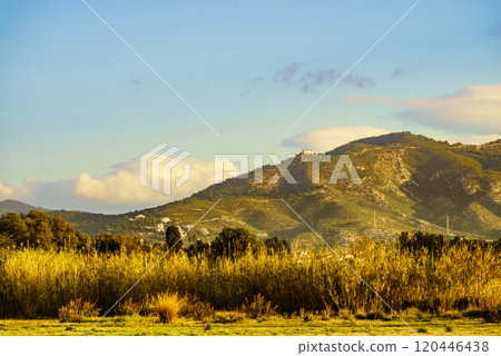 Spanish coast landscape with church on hill 120446438