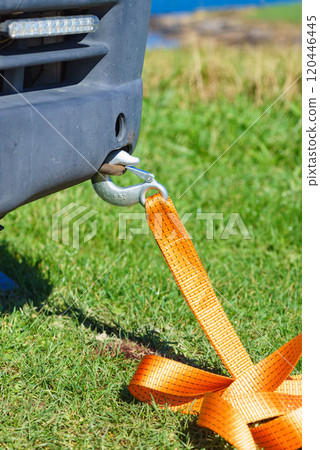 Tow hook with orange strap on car. Towing equipment. 120446445