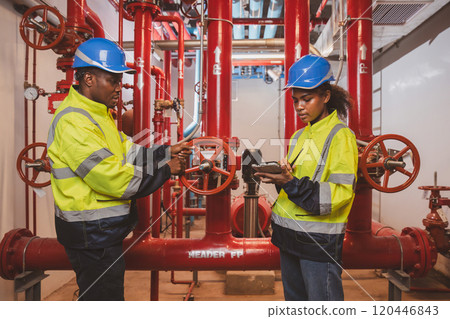 Engineer or technician work checking Fire suppression system and fire equipment. Engineer check red generator pump for water sprinkler piping and fire alarm control system Engineer or technician work checking Fire suppression system and fire equipment. Engineer check red generator pump for water sprinkler piping and fire alarm control system 120446843