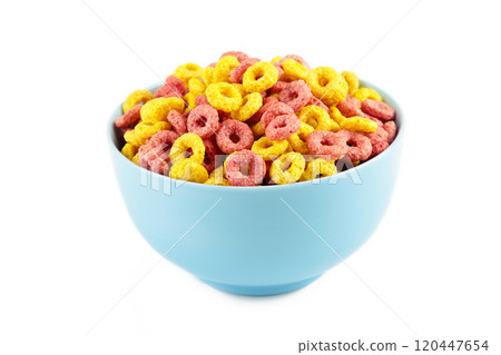 Colorful cereal loop rings on blue bowl isolated on white background. Breakfast food. Colorful cereal loop rings on blue bowl isolated on white background. Breakfast food. 120447654