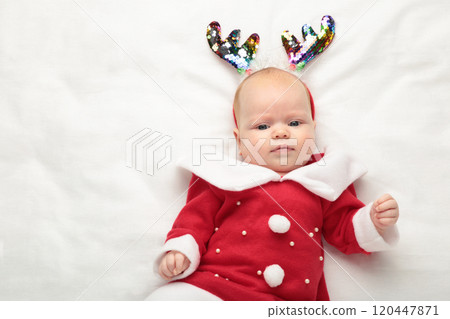 Baby Dressed up for First Christmas with christmas decoration on white background. Baby Dressed up for First Christmas with christmas decoration on white background. 120447871