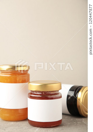 Assortment of jam jars mock-up. Jars with blank label on grey. Vertical photo 120447877
