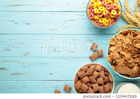 Variety of cereals in blue bowls, quick breakfast on blue wooden background. Vertical photo Variety of cereals in blue bowls, quick breakfast on blue wooden background. Vertical photo 120447889