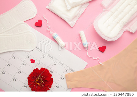 Women's panties with menstrual pads and tampons on pink background. Top view. Concept of critical days, menstruation, feminine hygiene Women's panties with menstrual pads and tampons on pink background. Top view. Concept of critical days, menstruation, feminine hygiene 120447890
