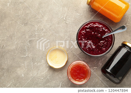 Assortment of jams on grey background with copy space. 120447894