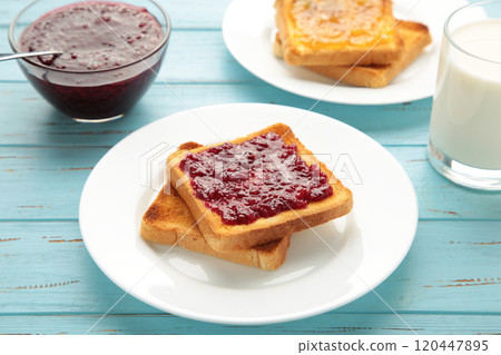 Sweet toasts with jam for breakfast on blue table Sweet toasts with jam for breakfast on blue table 120447895