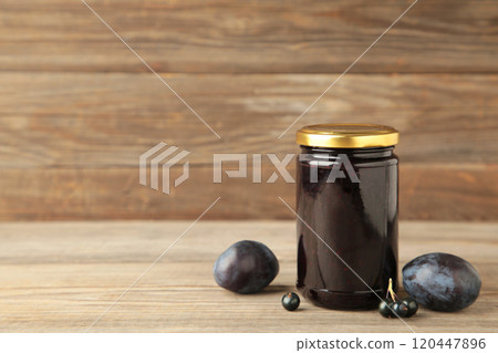 Plum jam and fresh plums on grey wooden background 120447896