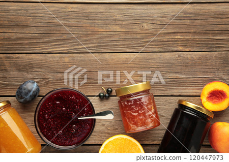 Assortment of jams, seasonal fresh berries and fruits on grey background with copy space. 120447973