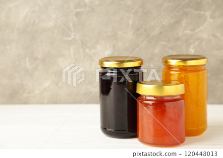 Assortment of jams, seasonal fresh berries and fruits on white background. Assortment of jams, seasonal fresh berries and fruits on white background. 120448013