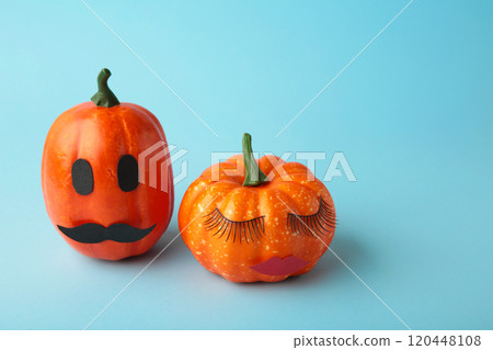 Halloween pumpkin with make up on blue. Minimal Holiday season concept background. Man and woman 120448108