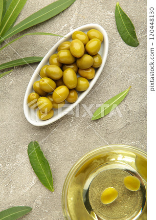 Olive oil with olive on grey background. Vertical photo Olive oil with olive on grey background. Vertical photo 120448130