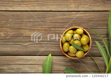 Fresh olives in bowl with leaves on grey background with copy space. Fresh olives in bowl with leaves on grey background with copy space. 120448217