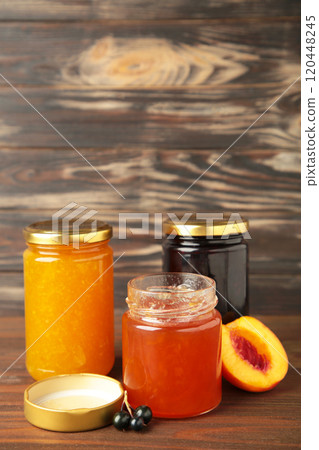 Homemade fruit jam in the jar on grey background. Top view Homemade fruit jam in the jar on grey background. Top view 120448245