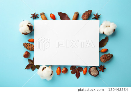 Autumn composition. Paper blank with dried flowers and leaves on blue background. Autumn, fall concept. Flat lay, top view, copy space, square 120448284