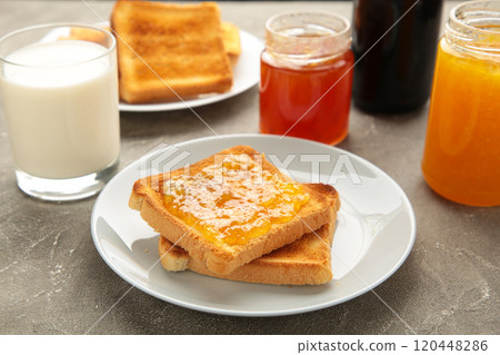 Sweet toasts with jam for breakfast on grey table 120448286