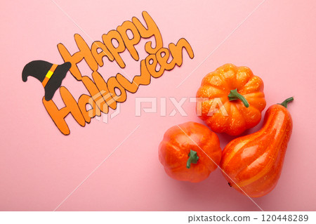 Halloween composition with pumpkins on pink background. View from above. Halloween composition with pumpkins on pink background. View from above. 120448289