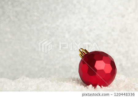 Red Christmas ball on glittering background. New Year 2022 120448336