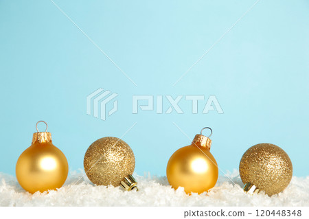 Golden Christmas baubles on snow. Flat lay. New Year 2022 120448348