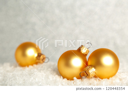 Golden Christmas baubles on snow. Flat lay. New Year 2022 120448354