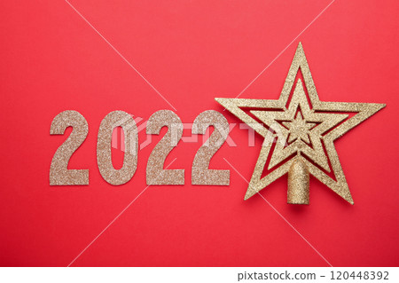 Inscription 2022 with christmas star on red background. Happy New Year. Flat lay. Inscription 2022 with christmas star on red background. Happy New Year. Flat lay. 120448392