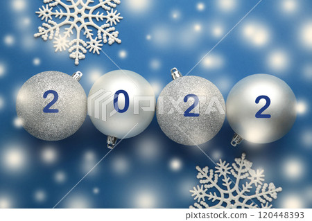 Inscription 2022 on christmas balls on blue background Inscription 2022 on christmas balls on blue background 120448393