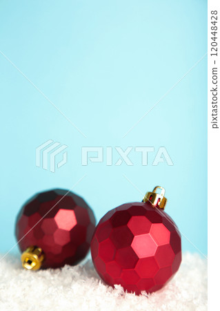 Gold Christmas decoration balls on blue background. Vertical photo. 120448428